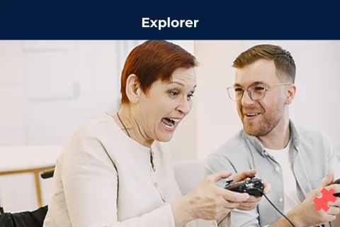 Une personne en fauteuil roulant joue au jeux vidéo avec une autre personne